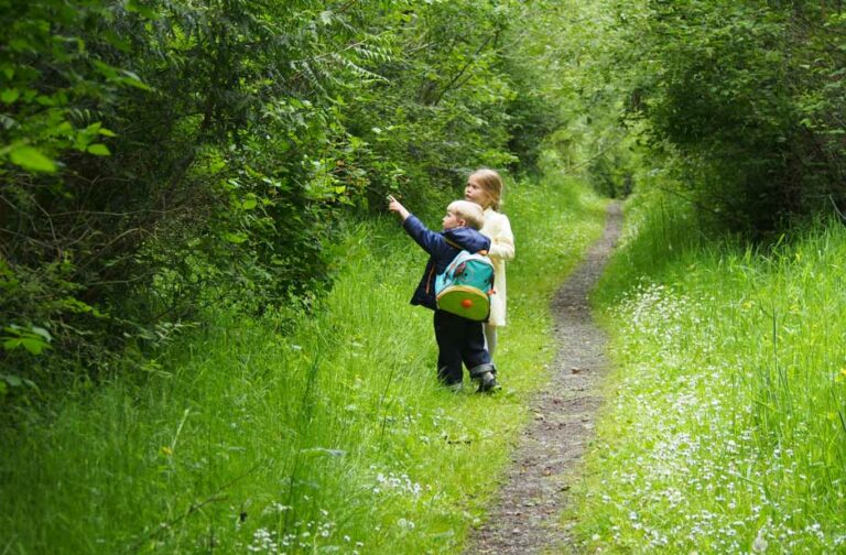 Photo of two children on a trail.