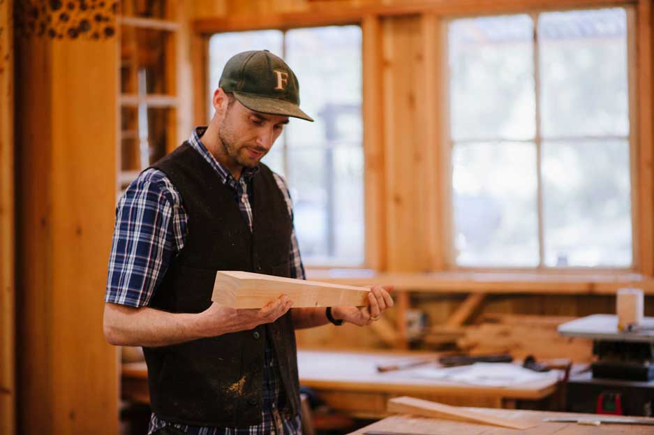 action-customwoodworking-large-for-web Cody making a leg for a custom table in the shop at Wayland Constructive