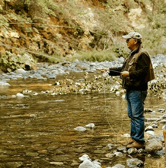 Photo of Ed Thompson fly fishing.