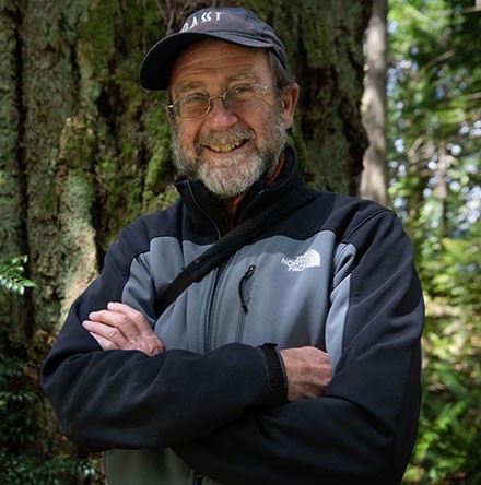 Tim Lawson smiling in front of a large tree.