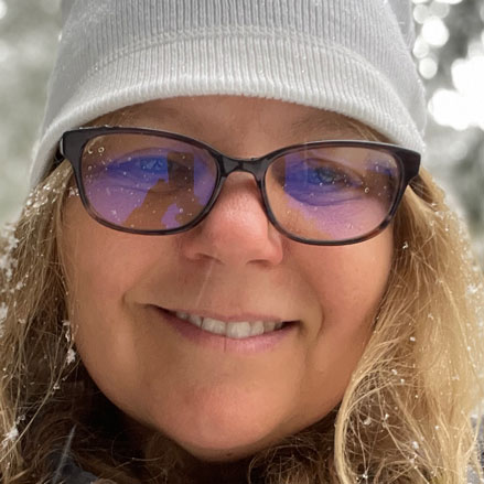 Smiling woman with snowflakes in her hair