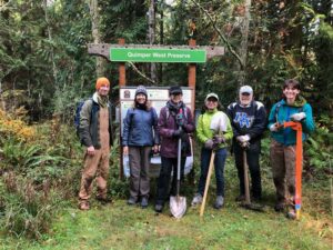 Six people in front of sign reading "Quimper West Preserve"