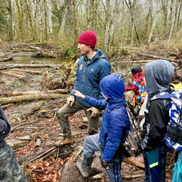 Guy and kids by river