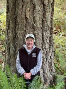 Woman in front of huge tree