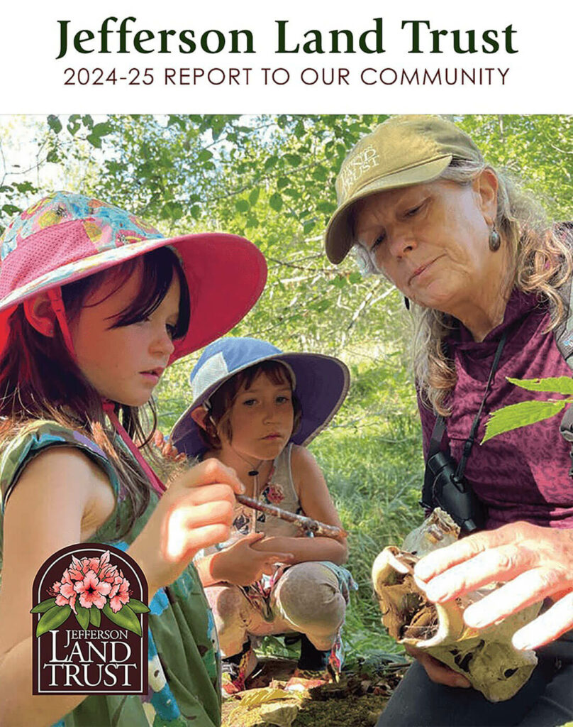 Image of the front cover of the 2024-25 Report to Our Community showing a woman holding something interesting that she's showing to two young girls.