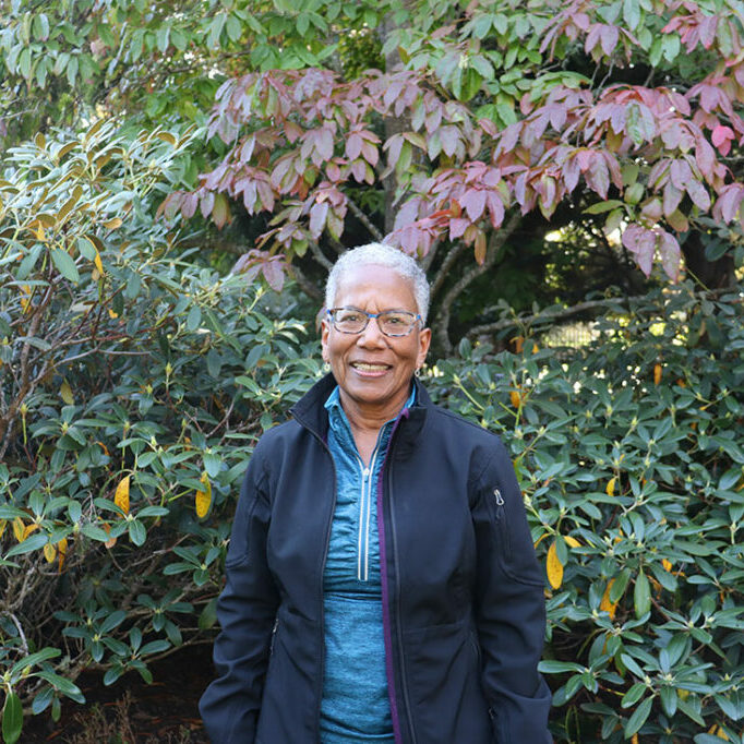 newIMG_4767 Smiling woman in front of shrubs